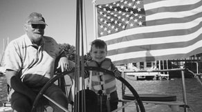 Grandson steers the boat