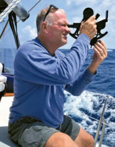 Sailor John Kretschmer takes a sun sighting