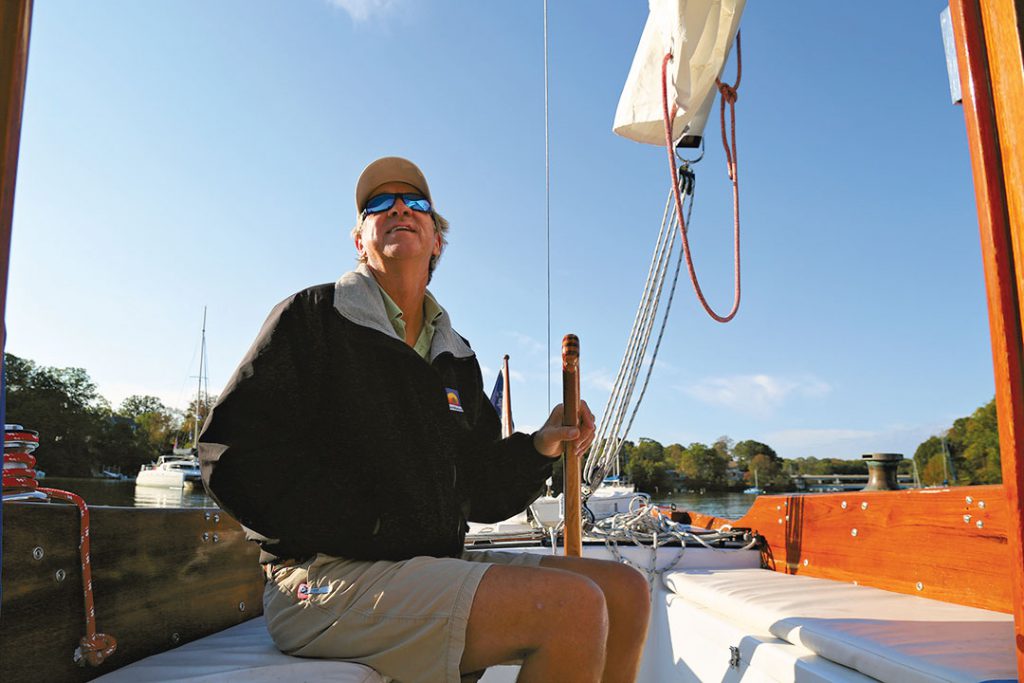 Johnny Clarke at the sailboat tiller