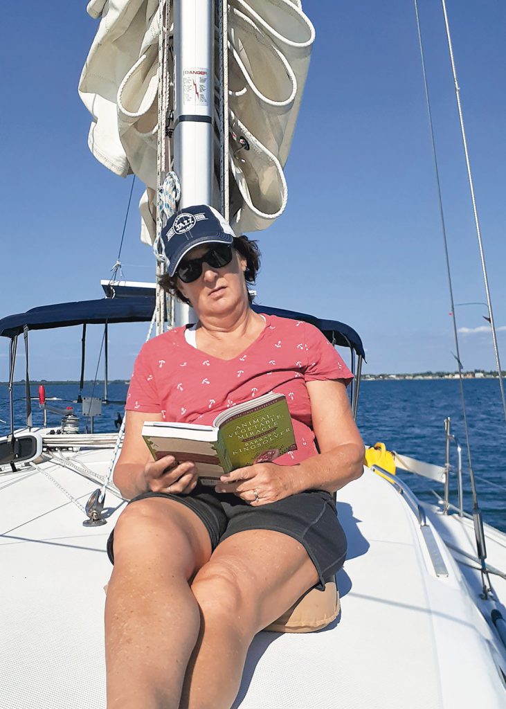 Reading a book on a sailboat