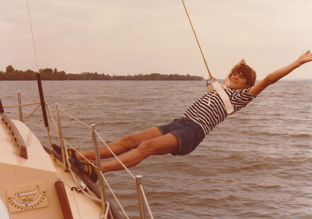 a teenager using a swing while on their sailboat