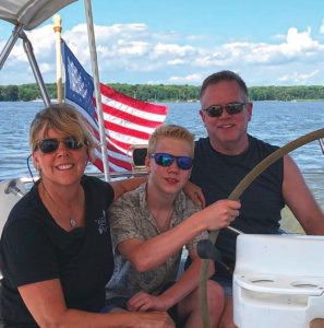 The Livezey family happily at anchoraboard their 1999 Beneteau 411, Hwyl.