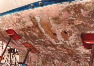 fairing thebottom after chemically
stripping paint from the
hull of the boat.
