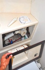 the framed,cutout rectangle with
holding tank hoses in the
background.