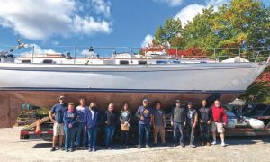 The crew at JohansonBoat Works, with the boat
looking like new after two
months of work.
