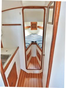 looking aft fromthe forward cabin, the
head sink is opposite the
toilet, with an opening
portlight for ventilation.