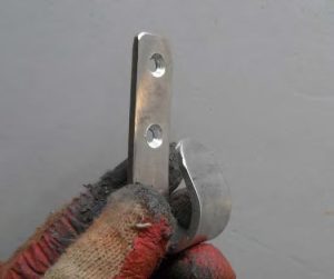 the finished hooks, fabricated from 1/8-inch by 3/4-inch by 5-inch aluminum flat bar.