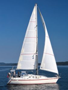 the CS 30 sports a fairly flatsheer, raked bow, reverse transom, and a
tall rig. Jack and Marilyn purchased a new
full-batten mainsail and 110% genoa.
These, along with an asymmetrical
spinnaker in a sock and a seldom-used
150% genoa, complete the sail inventory.
Lazy-jacks make easy work of lowering
the mainsail.