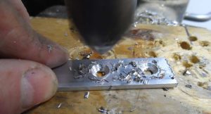 countersinking the holes for #8 fasteners. After the holes are drilled, the corners are rounded and smoothed with a sander or file.