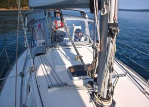 Halyards are led aft from the mast base through turning blocks.