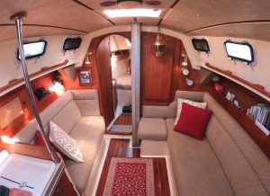 the use of numerous fiberglass moldings and composite panels is evident in this view of the saloon and forward cabin — most significantly, the pan that forms the sole and berth foundations. Note the molding that covers the bulkhead/deck join.