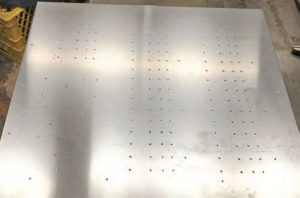 the new panel is prepared for drilling with center punches for holes.