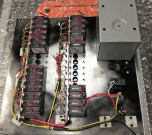 Note the lower ends of the buss bars extending past the bottom circuit breakers, drilled to enable larger wiring.