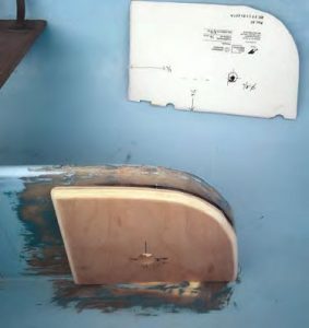 the new marine plywood reinforcingpanel over multiple layers of 1708 fiberglass laid up on a temporary backer. The template for locating the centerboard shaft hole is in the background.
