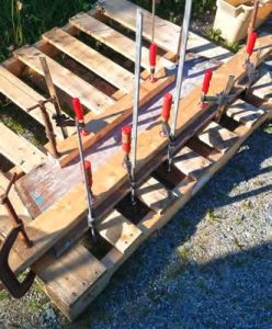Chi's aft thwart was badlycurled. After soaking in wet cloths and bags, it was clamped until it flattened out.