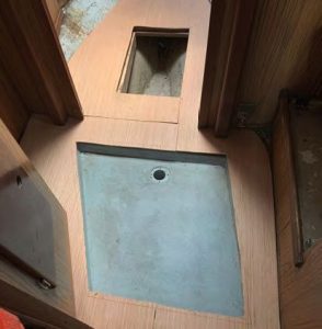 After trimming the shower pan hole, Tomtested the look and fit of the flooring
material.