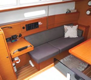 the compact navstation is minimal for a cruising yacht;
one sits at the end of the port settee.
Regarding hidden fiberglass modules,
note the barely visible section of the
floor grid.