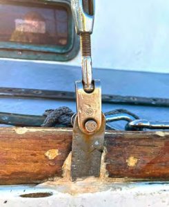 The original embedded chainplates with Merriman logos on the hardware, suggesting they are likely original to the boat.