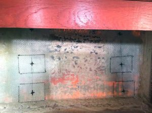 the same port bulkhead after sanding andlaying fiberglass reinforcements. The new chainplates
alignments are drawn and the G10 backplates are ready
to be glued in.