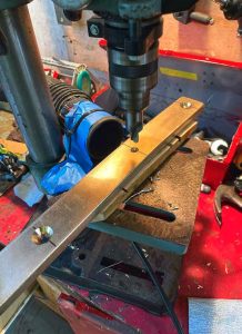 drilling the holes and countersinks in the bentchainplates. The vacuum tube taped to the drill press
worked well to keep bronze shards in check.