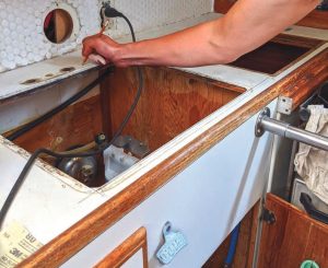 Scott marks the cut and drill locations for the new faucet.