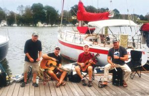 The author (with guitar) and bandmatesperform on the dock in front of Sundown before the restoration.