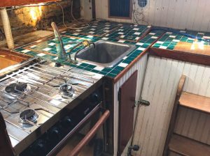 Calypso's original galley, with the outboard storage dismantled.