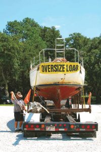 Billy Ray works on the straps holding Traveller to the trailer.