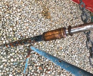 The cutlass bearing is seized to the prop shaft. The setscrews have cut the bearing shell, forming a separate ring.