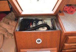 Opening the top of the companionway helps keep the alternator cool, but is a poor solution.