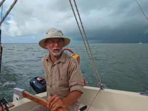 Robert gets the inexpensive, seldom used outboard fired up to move anchorages.