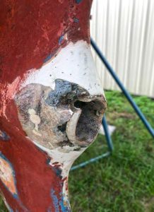 The damaged stern tube, after the author sanded the surrounding area and picked away the old filler. Prior setscrew holes are visible and the stern tube seems to be worn somewhat eccentrically, based on the remaining tube thickness.
