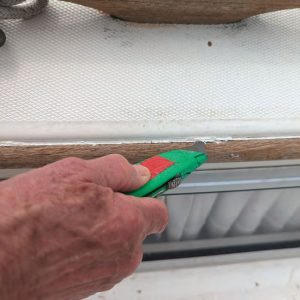 tidying up the sealant in the final joint before sealing the wood with Semco Teak Sealer.