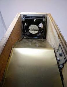 Aluminum flashing sheet directs the air past the bulb for even heating