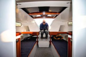 Scott sits in the companionway of One More Time. The revamped interior is simple for racing but comfortable enough for weekend cruising