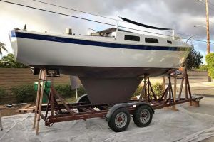 Looking spiffy with a racing bottom and newly paintedtopsides, the rebuilt One More Time rests on her trailer,
ready to travel.