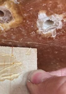 A dab of hot glue on the plywood piecesprevented the epoxy from sticking to
them as it hardened.