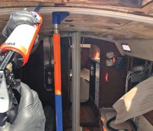 Johnny Clarke applies a finishingbead of West System 610 epoxy to glue the athwartship
supports to the overhead fiberglass.