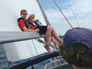 Sam, Graham’s son, and his friend, Tuskar, enjoy asnack hanging on the boom while sailing Secret Plans
out of Halifax Harbor, bottom right.rain and fog off the Nova Scotia Atlantic coast last
summer