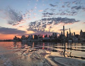 Just at dawn, the New York City skylineis outlined by early light, and the river is
blissfully mirror-like with little traffic.