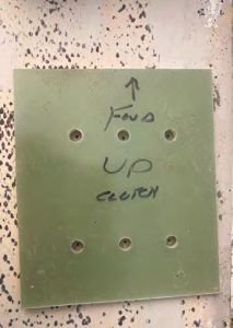 The backing plate for the clutch,hot-glued to the deck to provide a
template for precise hole location, before
and after drilling.