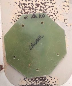 Toprecisely locate where
the epoxy-filled holes
needed to be drilled for
one of the winches, Bob
hot-glued the pre-drilled
G-10 backing plate to the
deck and used its holes
as a reference. He used
this method for all of the
hardware that required
backing plates.