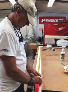 Johnny measures a piece of the board