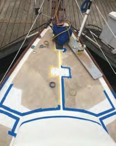 The foredeck inmid-repair, and after completion, coated
with new KiwiGrip non-skid.