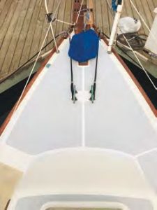 The foredeck in
mid-repair, and after completion, coated
with new KiwiGrip non-skid.