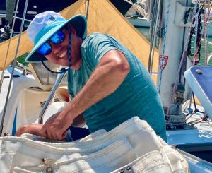 Good Old Boat Editor Andy Cross works on the mainsailaboard his Grand Soleil 39, Yahtzee.