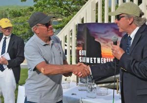 Tom Alley shakes hands with Essex YachtClub Rear Commodore Bill Gunther, who
recognized Tomfoolery for being the boat
to travel farthest to compete in the 2020
Sam Wetherill Race,