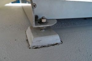 Drew used DIY Garolite studs to mountsolar panels on his boat. Double nuts on
the studs allow for accommodation of
compound curvature and easy removal.