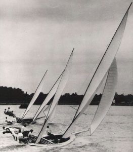 Island Blossom (background) racing under a fullpress of Egyptian cotton sails made by Downes
Curtis, above right. Photo, undated, Chesapeake Bay
Maritime Museum Collection (36.3)