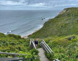 Katie climbs the steps up from the beachalong the southern shore of Block Island
near the Southeast Lighthouse. This
was the lee shore Tomfoolery’s crew was
steering clear of during the Wetherill
Race; they could hear the surf crashing on
the shore from a mile off.